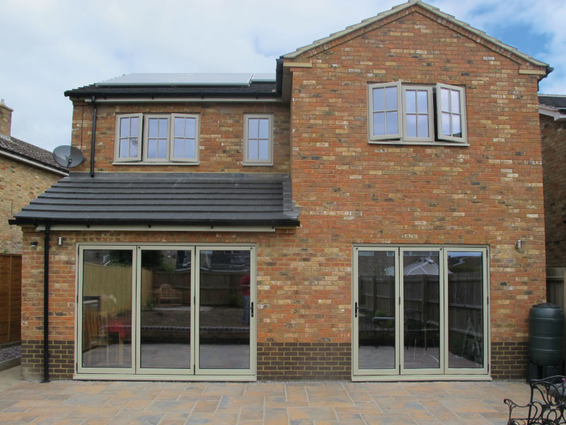 Brick home with green aluminium bi-fold doors